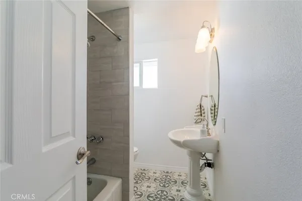 a bathroom with a sink a mirror and a toilet