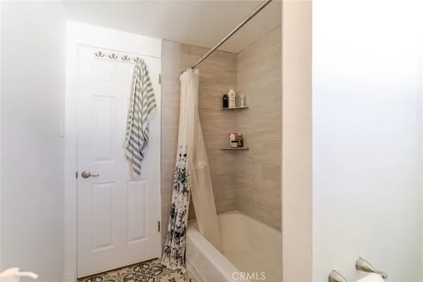 a bathroom with a bathtub and shower