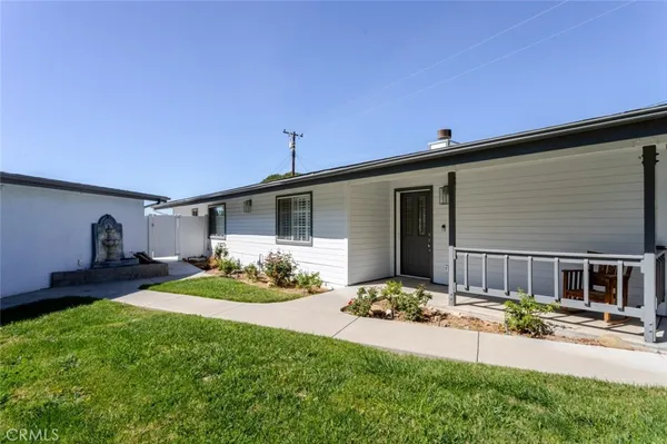 a front view of a house with a yard and porch