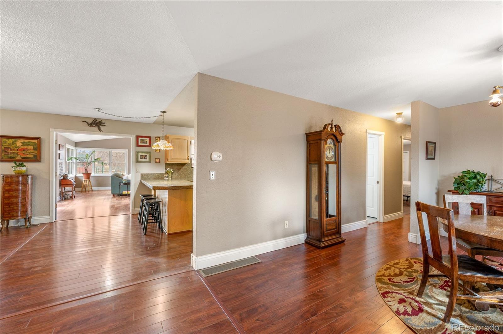 6263 Laodicea Road Longmont, CO 80503 - Photo 15 of 45 a view of a living room or kitchen with furniture and wooden floor