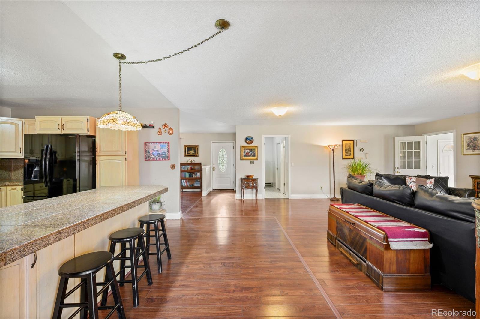 6263 Laodicea Road Longmont, CO 80503 - Photo 18 of 45 a living room with furniture and a chandelier