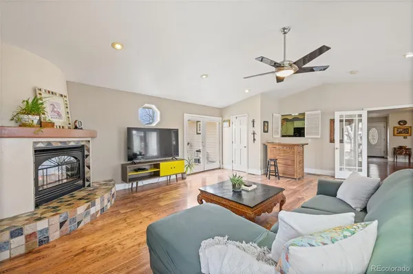 a living room with furniture and a wooden floor