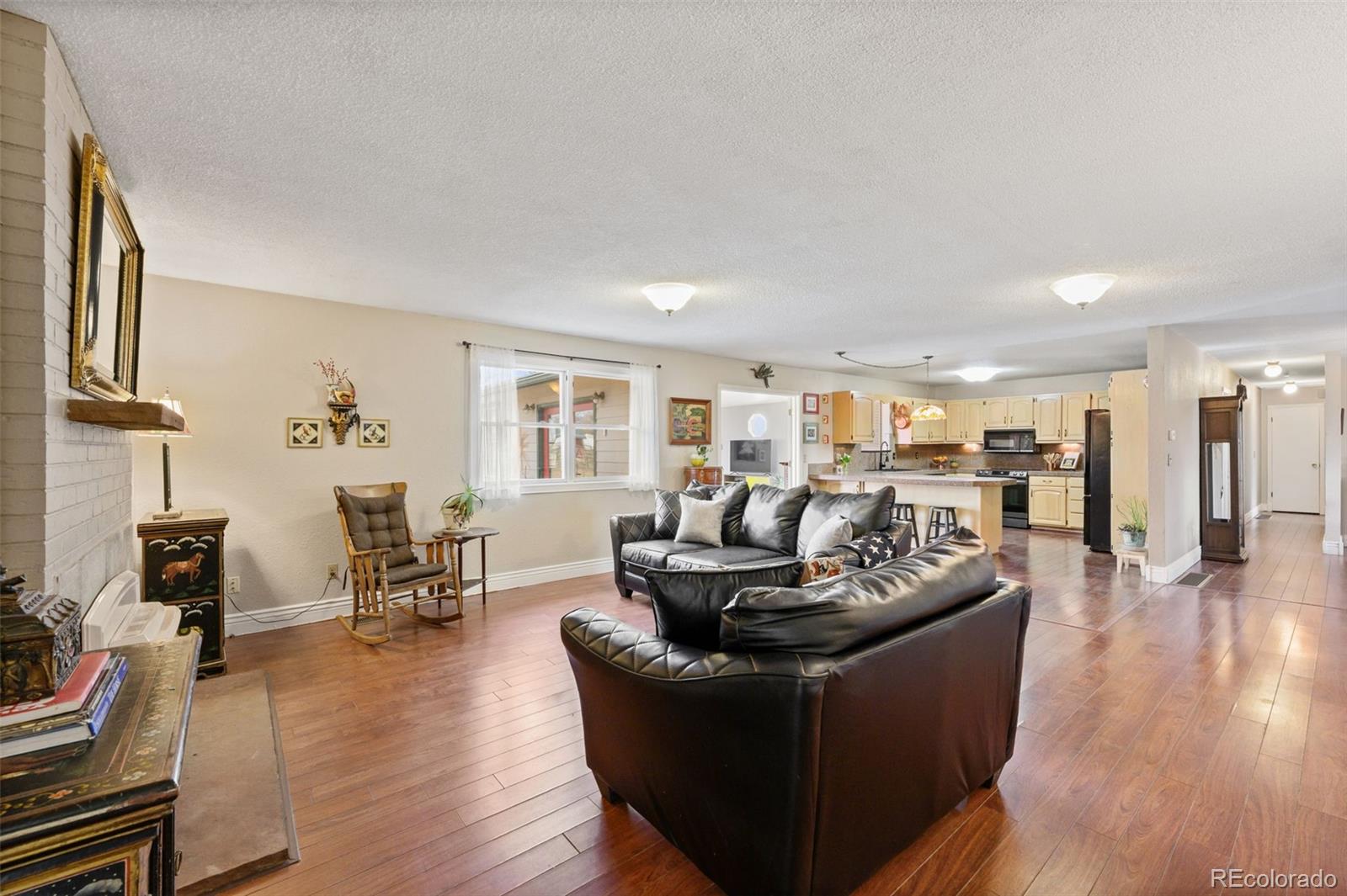 6263 Laodicea Road Longmont, CO 80503 - Photo 22 of 45 a living room with furniture and a wooden floor