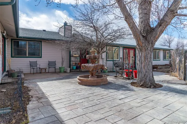 a backyard of a house with lots of green space and plants