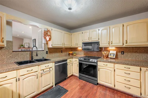a kitchen with granite countertop white cabinets and white appliances