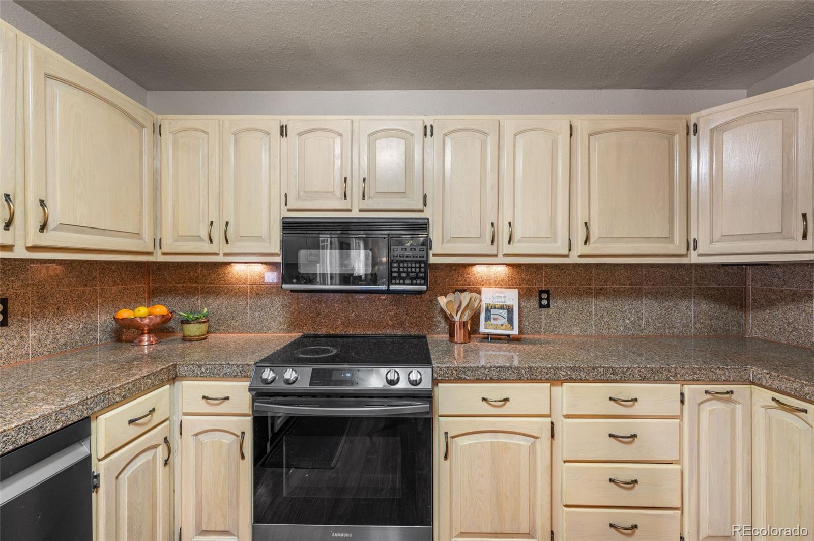 6263 Laodicea Road Longmont, CO 80503 - Photo 26 of 45 a kitchen with granite countertop white cabinets and white appliances