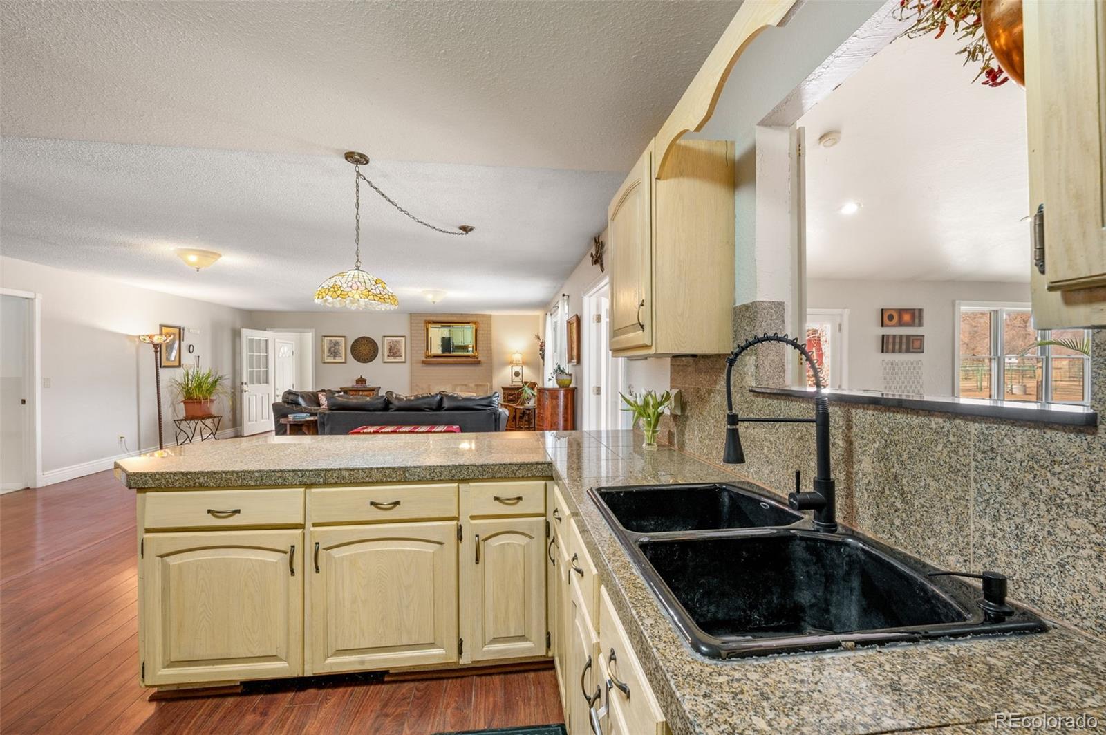 6263 Laodicea Road Longmont, CO 80503 - Photo 29 of 45 a kitchen with white cabinets and sink