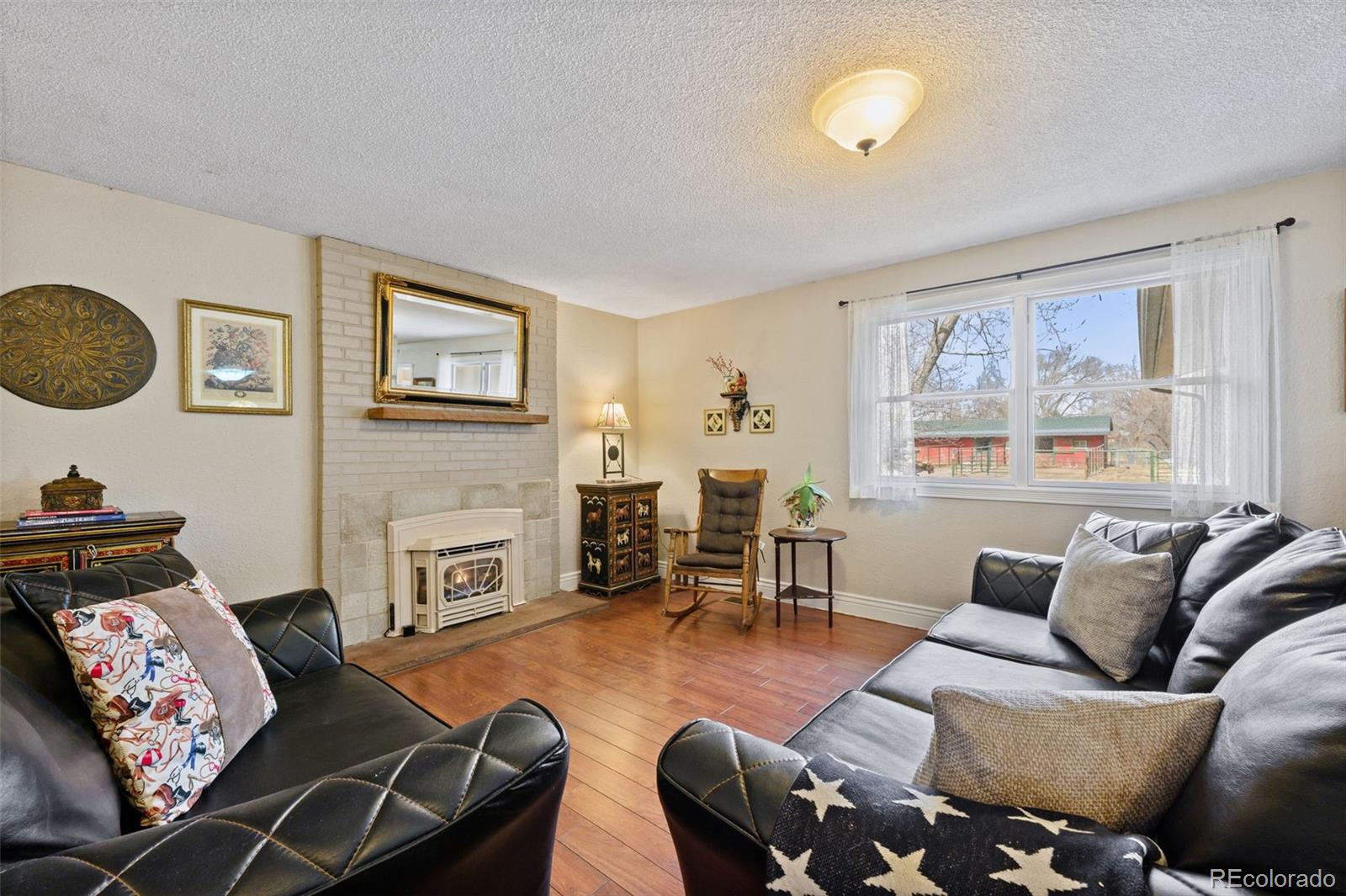6263 Laodicea Road Longmont, CO 80503 - Photo 30 of 45 a living room with furniture and a fireplace