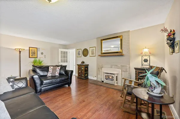 a view of a livingroom with furniture and hardwood floor
