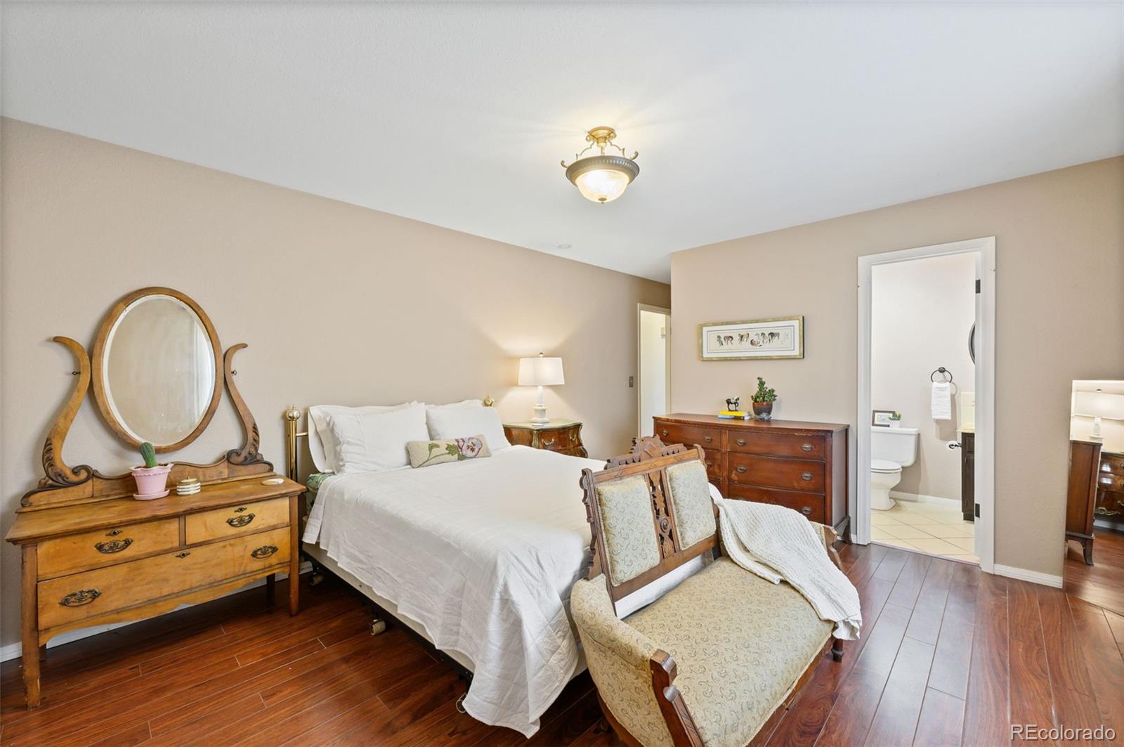 6263 Laodicea Road Longmont, CO 80503 - Photo 37 of 45 a bedroom with a bed and wooden floor