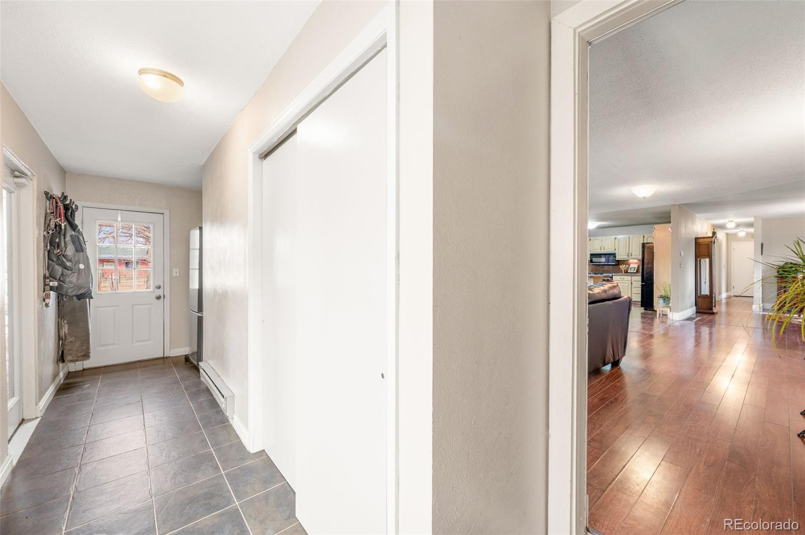 6263 Laodicea Road Longmont, CO 80503 - Photo 43 of 45 a view of a hallway view with wooden floor and a living room