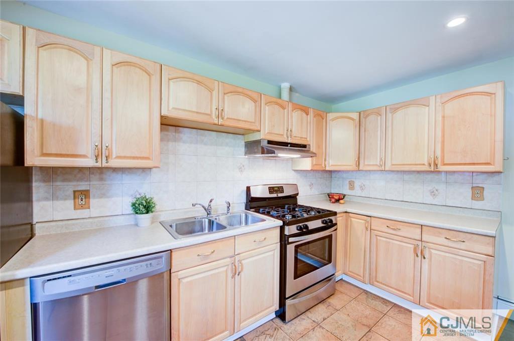 31 Raleigh Road Edison, NJ 08817 - Photo 8 of 23 a kitchen with white cabinets and white appliances