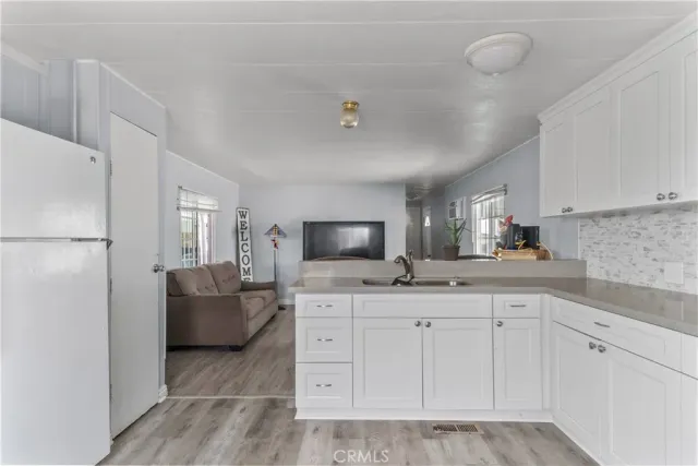 a kitchen with cabinets and window