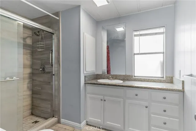 a bathroom with a granite countertop sink mirror and double