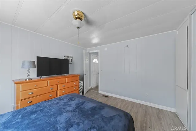 a bedroom with a bed and flat screen tv