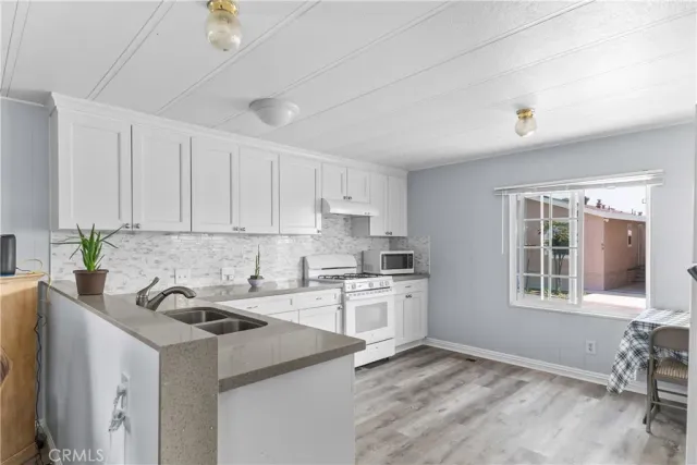 a view of room with window and refrigerator
