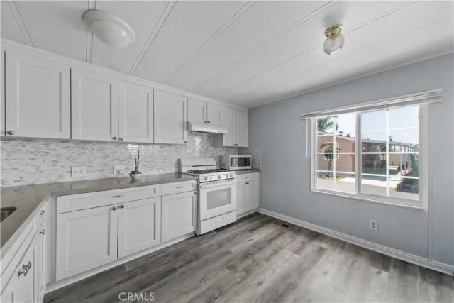 a kitchen with sink cabinets and window