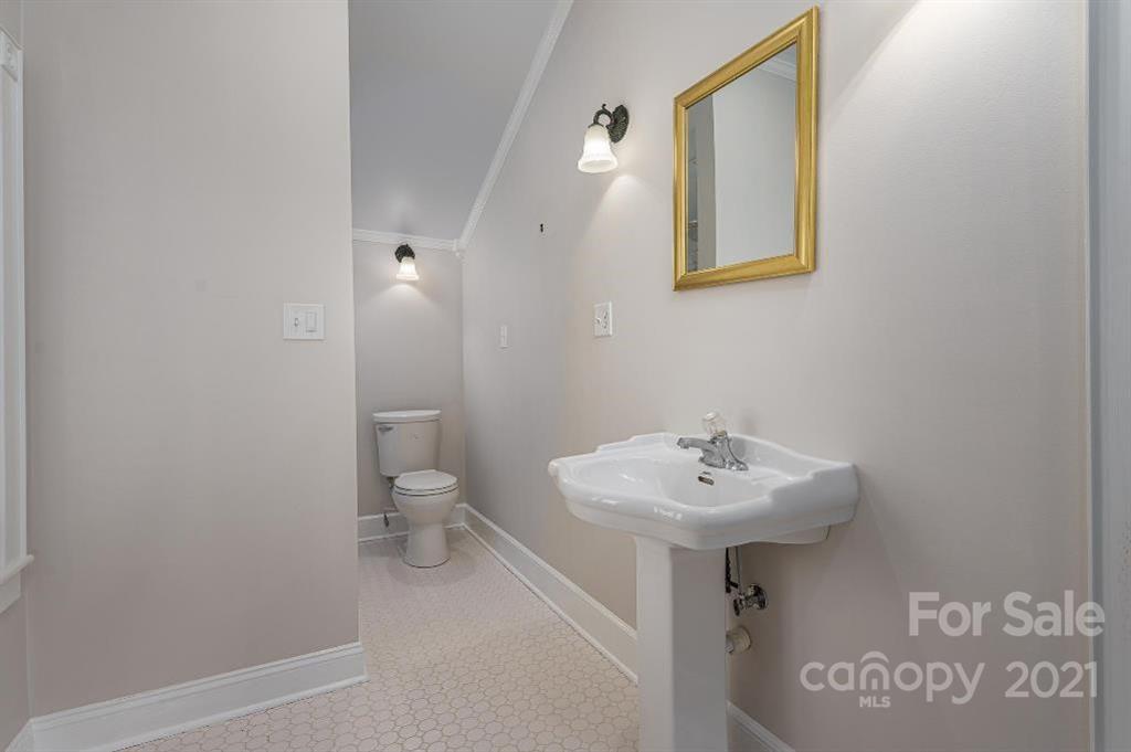 2497 Settlemyre Bridge Road Newton, NC 28658 - Photo 22 of 40 a bathroom with a sink a toilet and a mirror
