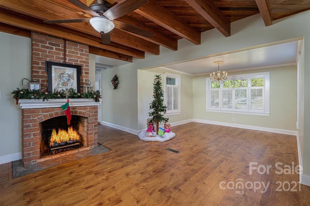 2497 Settlemyre Bridge Road Newton, NC 28658 - Photo 8 of 40 a view of an empty room with a fireplace and window