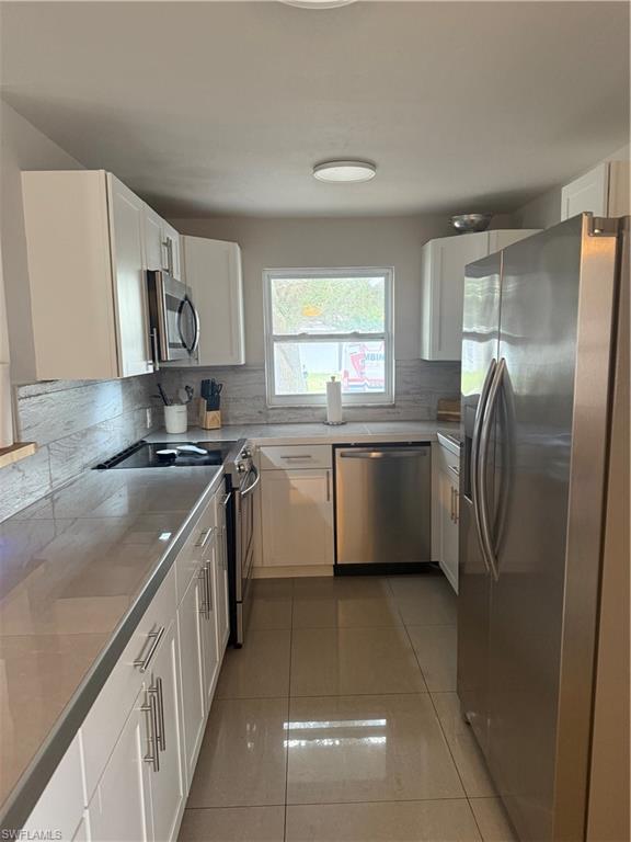 1635 Lowell Court Fort Myers, FL 33907 - Photo 15 of 15 a kitchen with stainless steel appliances granite countertop a sink a stove a refrigerator a washer dryer and a cabinets