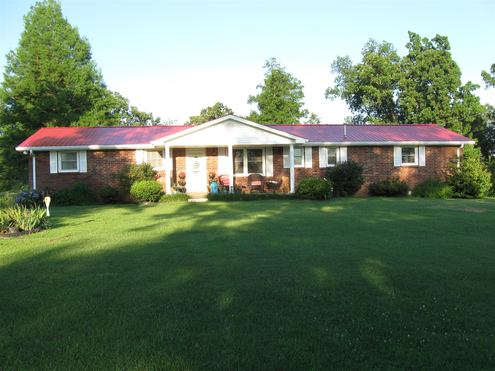 213 Black Road Dickson, TN 37055 - Photo 1 of 27 a front view of a house with a garden