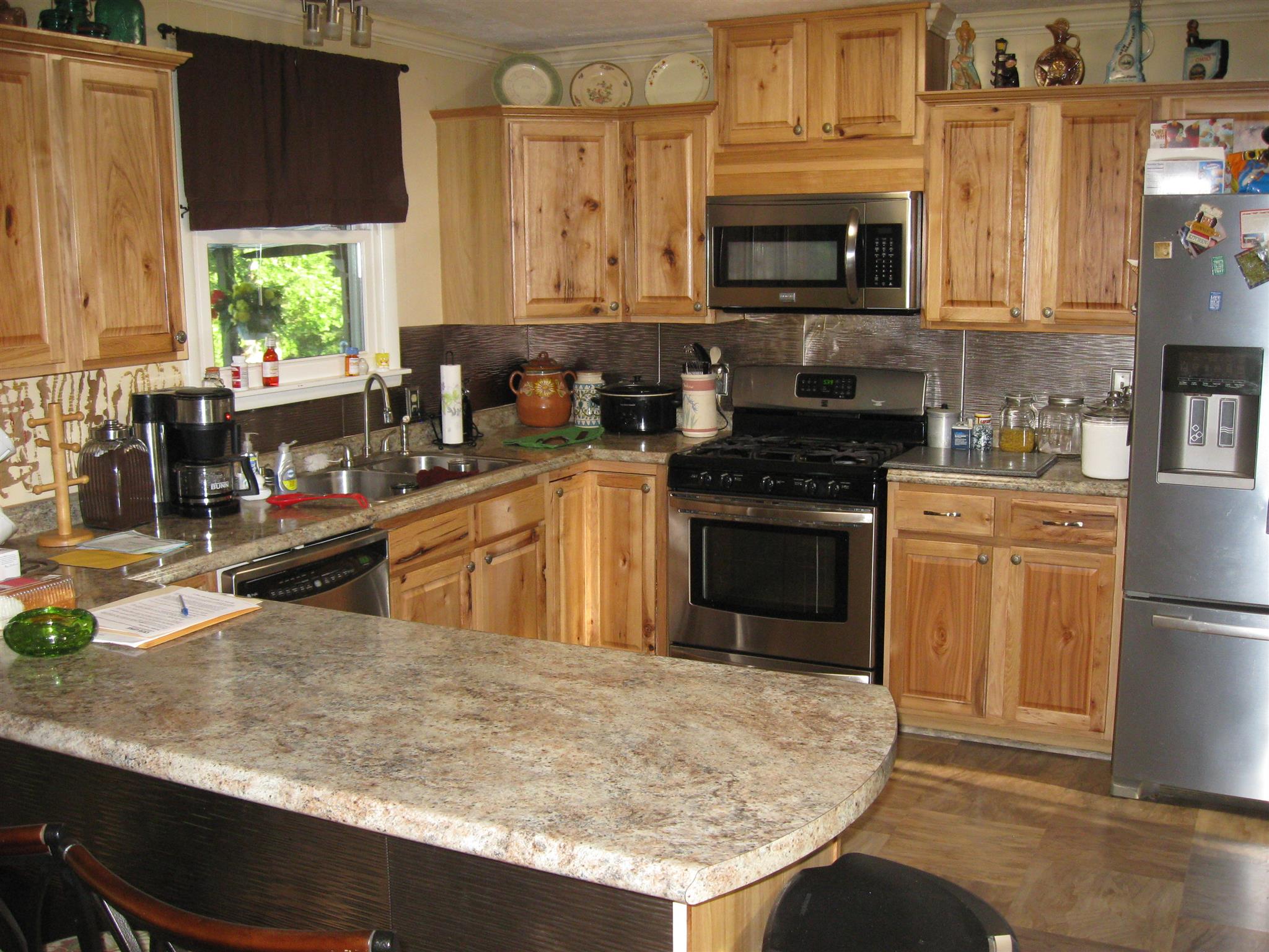 213 Black Road Dickson, TN 37055 - Photo 15 of 27 a kitchen with stainless steel appliances granite countertop a stove a sink and a microwave