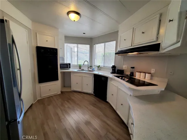 a large kitchen with a large window and refrigerator
