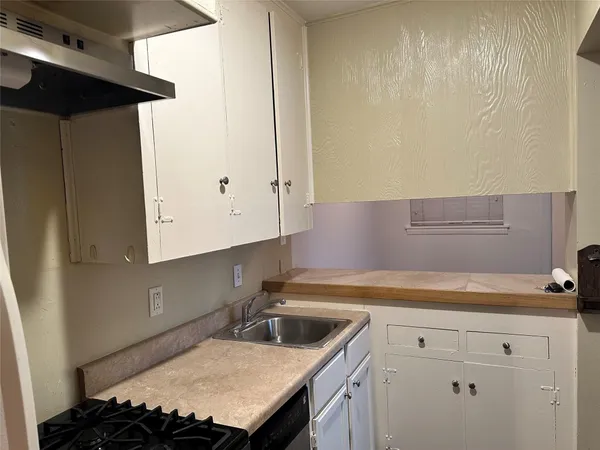 a kitchen with a refrigerator and a sink