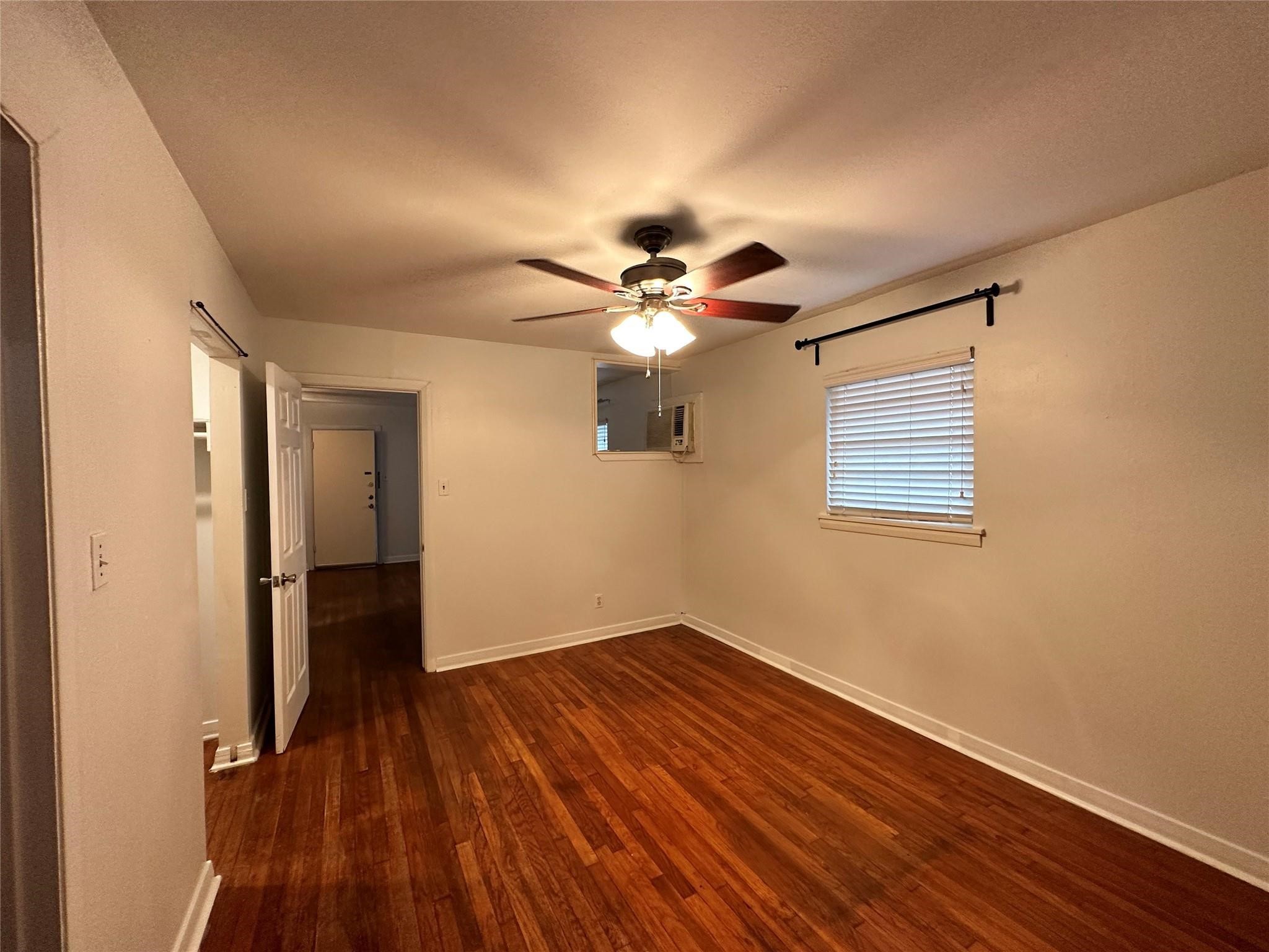 2022 Branard Street, Unit 5 Houston, TX 77098 - Photo 4 of 16 a view of a room with wooden floor and ceiling fan