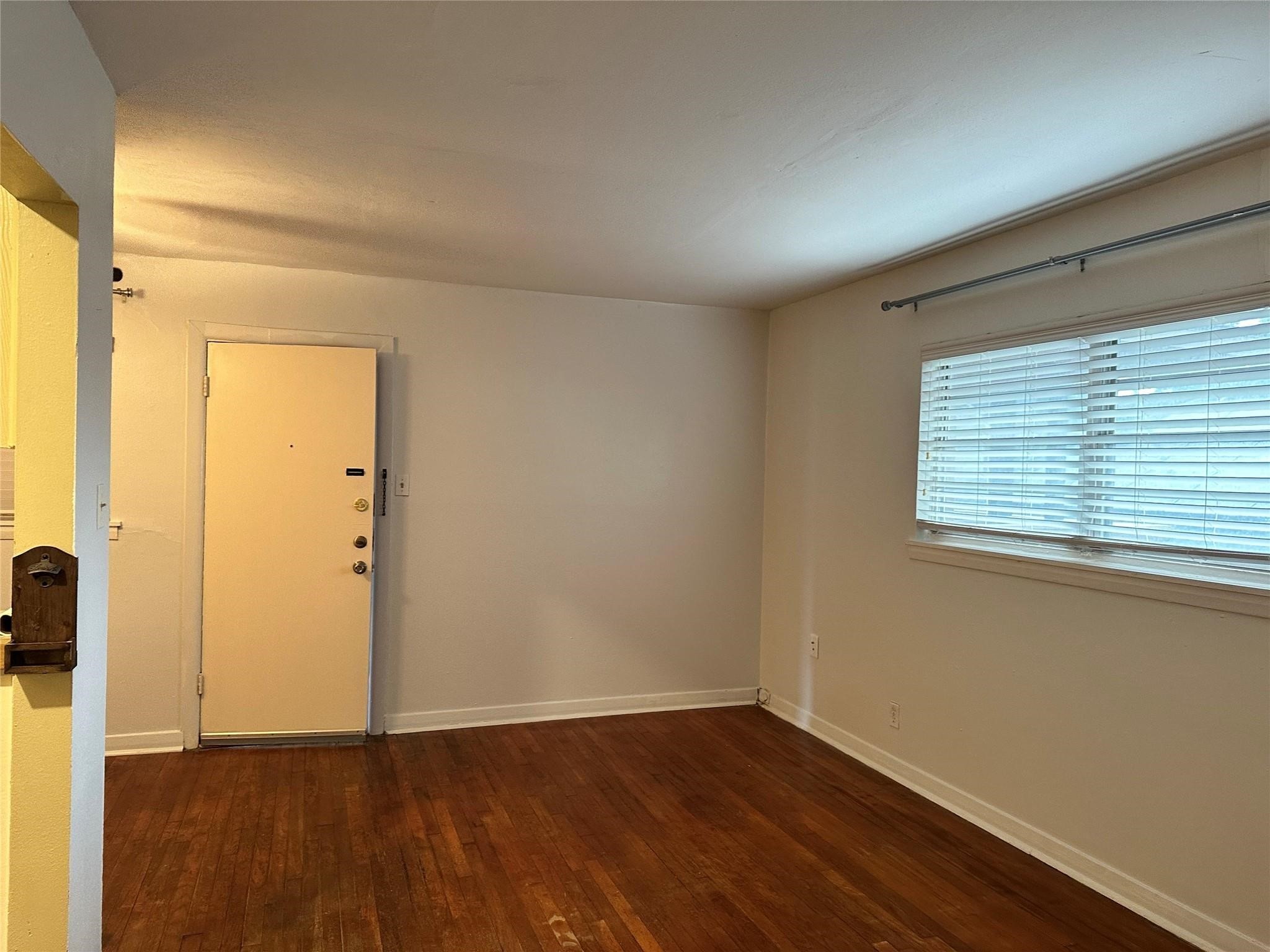 2022 Branard Street, Unit 5 Houston, TX 77098 - Photo 5 of 16 an empty room with wooden floor and a window