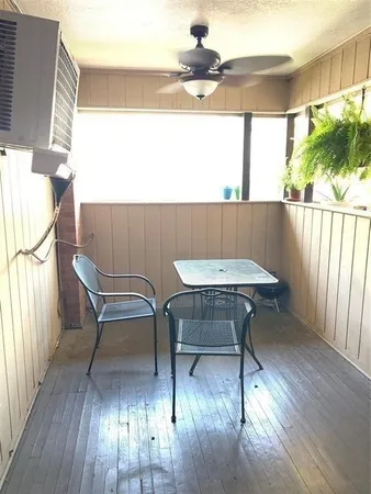an empty room with wooden floor and entrance
