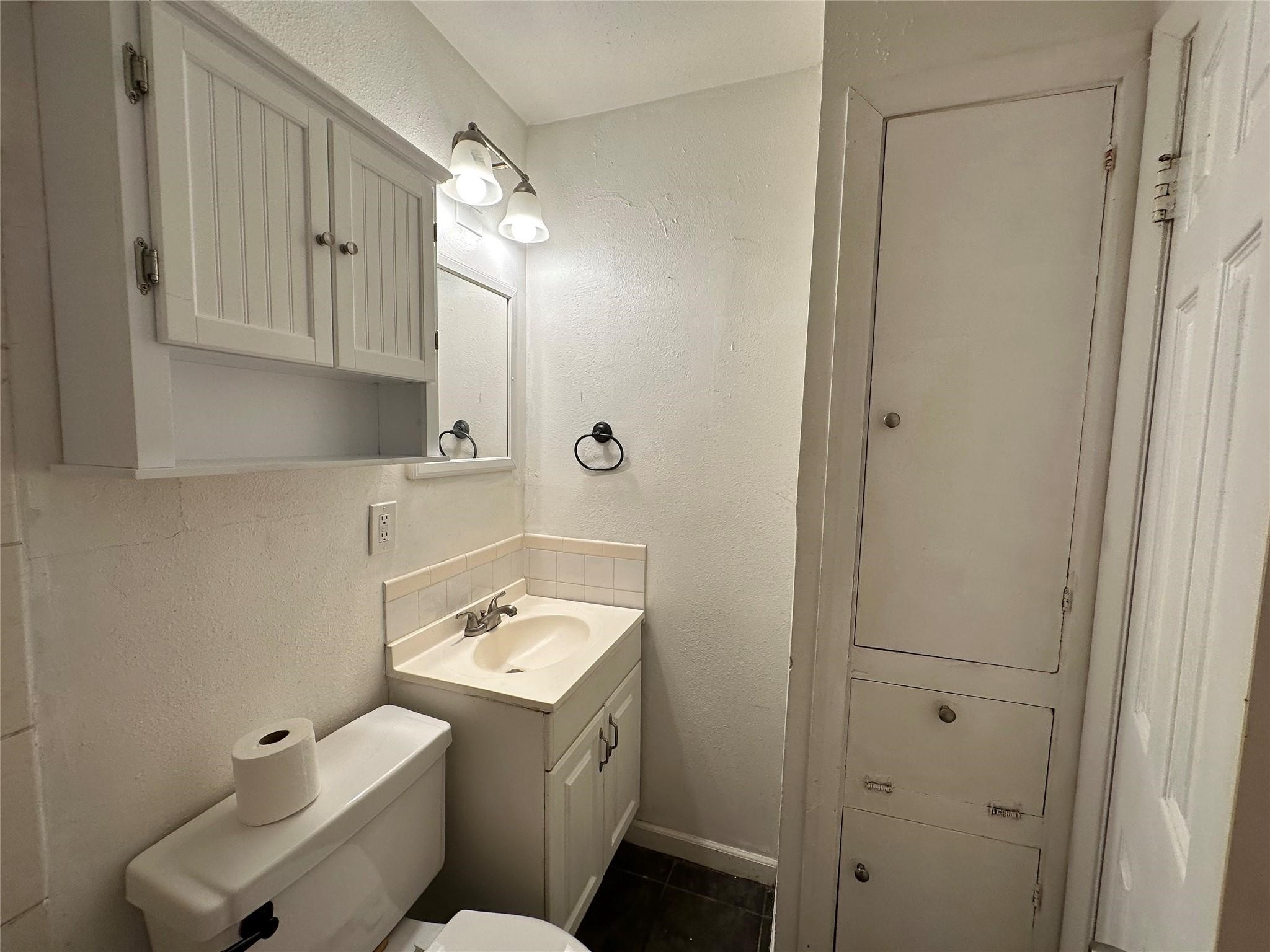2022 Branard Street, Unit 5 Houston, TX 77098 - Photo 10 of 16 a bathroom with a sink toilet and vanity
