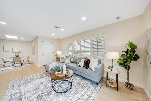 a living room with furniture a window and a table