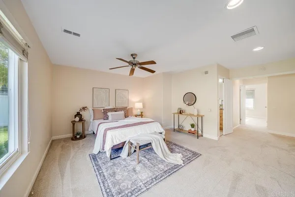 a bed room with a bed mirror and a window