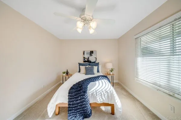 a bed sitting in a bedroom next to a window