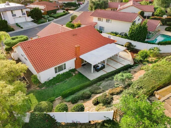 an aerial view of a house with a yard and trees