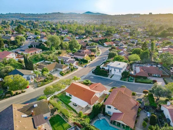 an aerial view of residential houses with outdoor space