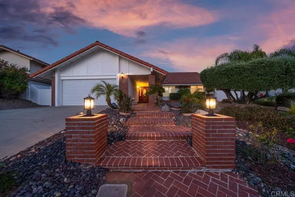 a view of house with yard and outdoor seating