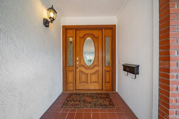 a view of a entryway door with wooden floor