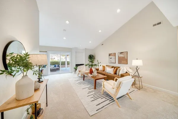 a living room with furniture and a potted plant
