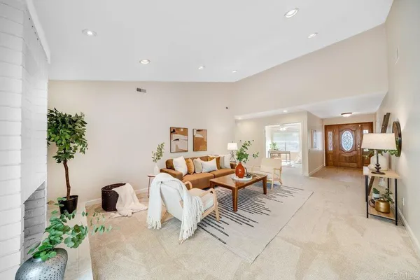 a living room with furniture and a potted plant