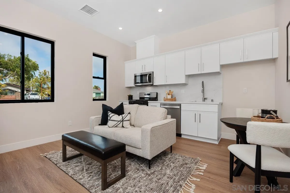 1645 Hunsaker Street Oceanside, CA 92054 - Photo 16 of 22 a living room with furniture a rug and kitchen view