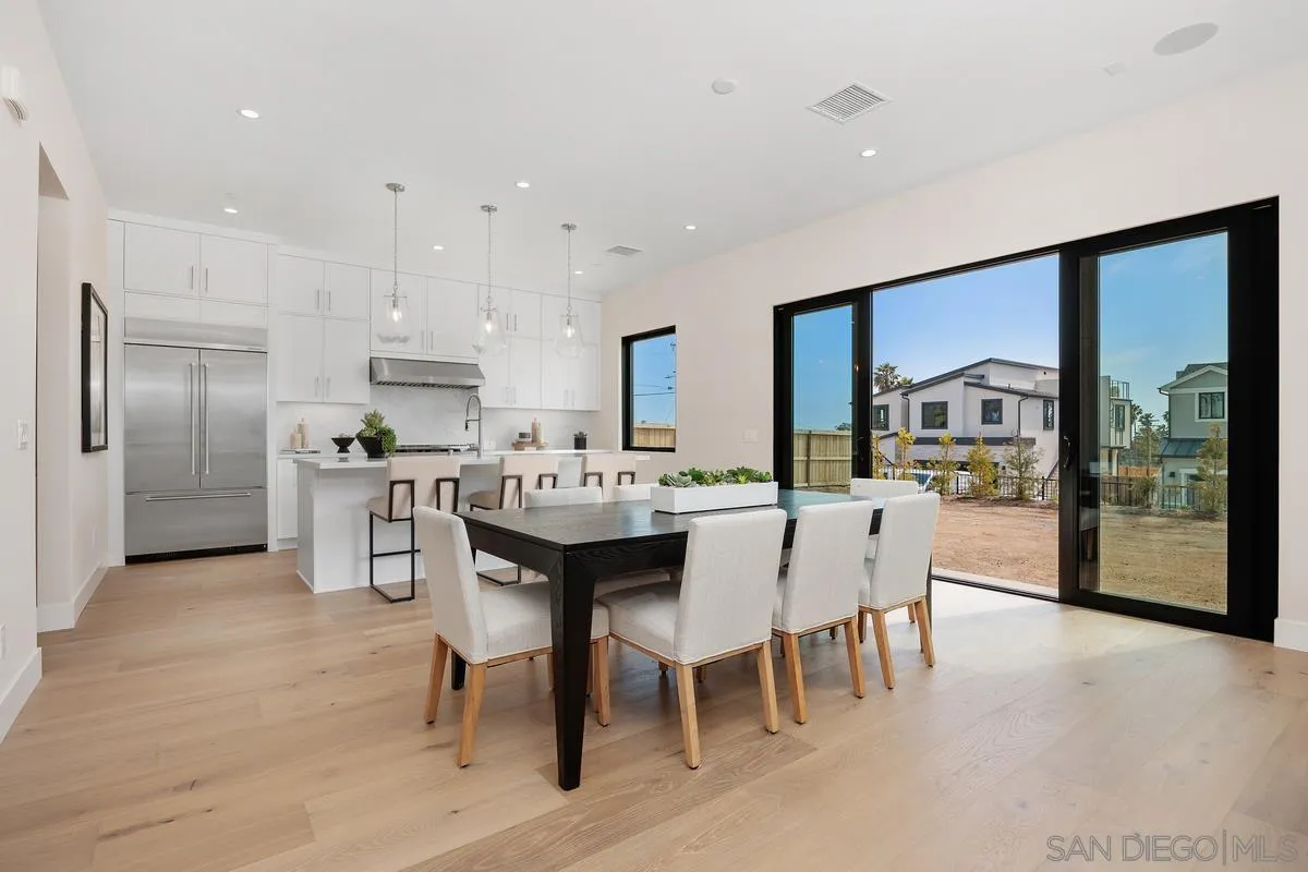 1645 Hunsaker Street Oceanside, CA 92054 - Photo 2 of 22 a kitchen with stainless steel appliances kitchen island granite countertop a table chairs and a refrigerator