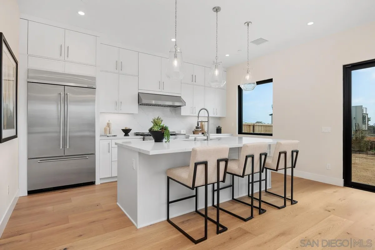 1645 Hunsaker Street Oceanside, CA 92054 - Photo 3 of 22 a kitchen with stainless steel appliances granite countertop a refrigerator a sink and a stove top oven