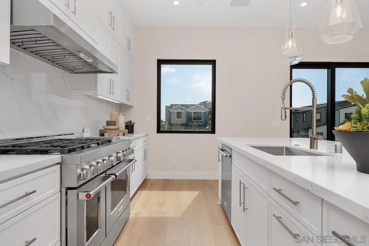 1645 Hunsaker Street Oceanside, CA 92054 - Photo 4 of 22 a kitchen with stainless steel appliances granite countertop a sink stove and cabinets