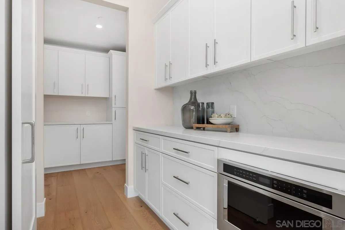 1645 Hunsaker Street Oceanside, CA 92054 - Photo 5 of 22 a kitchen with white cabinets and appliances