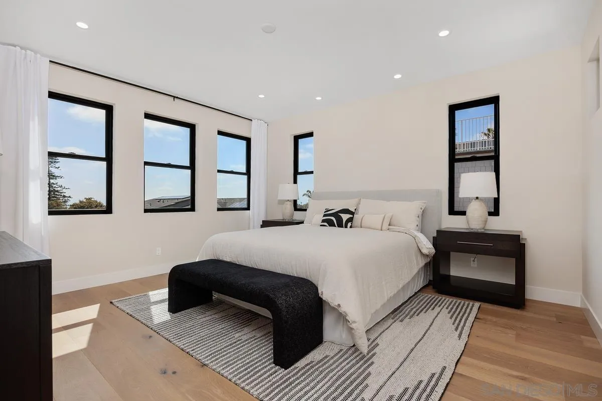 1645 Hunsaker Street Oceanside, CA 92054 - Photo 8 of 22 a bedroom with a large bed and a couch