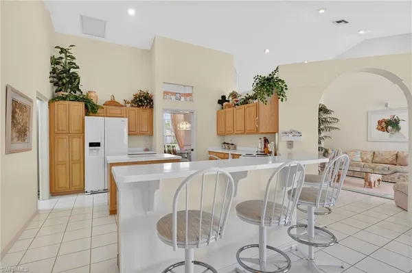 a large kitchen with a table and chairs in it