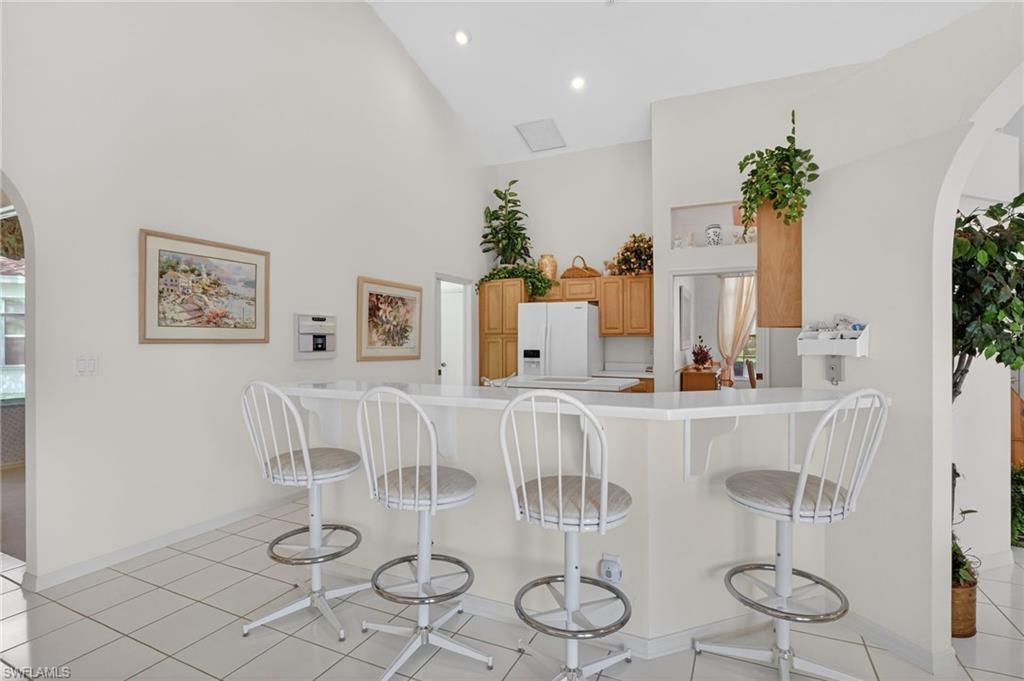 6687 Huntley Lane South Naples, FL 34104 - Photo 12 of 37 a view of a dining room with furniture