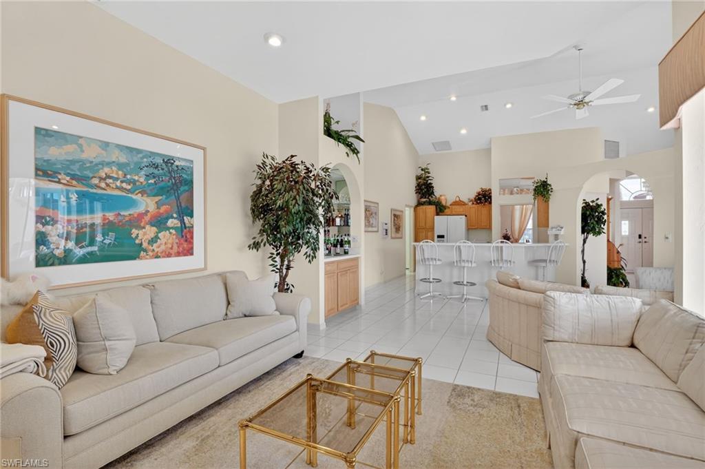 6687 Huntley Lane South Naples, FL 34104 - Photo 15 of 37 a living room with furniture and a large window